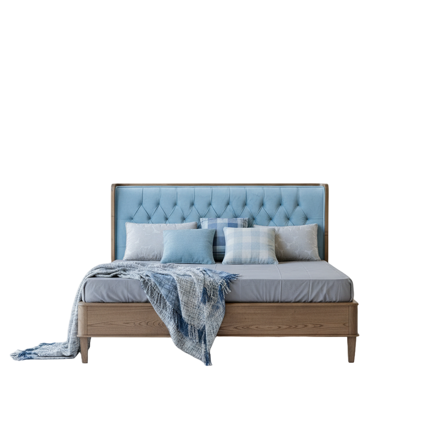 Bed with tufted headboard and pillows on a white background
