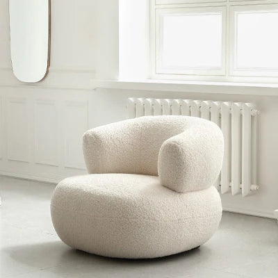 Sillón moderno de barril bouclé: un elegante detalle curvo para el salón.