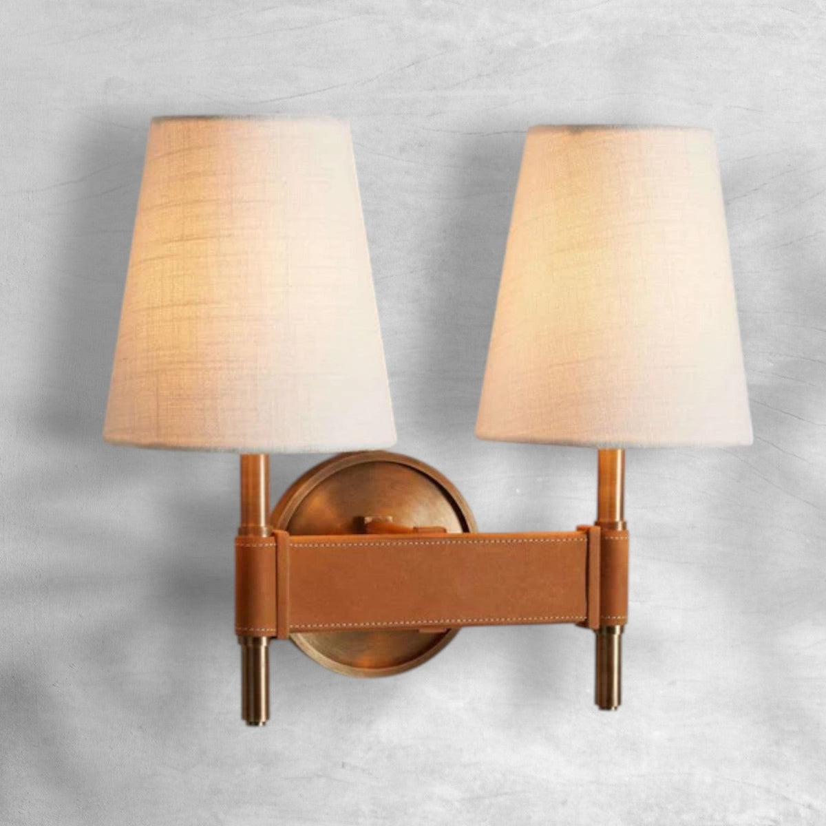Antiqued Brass Wall Sconce with Leather Stitching and Linen Shades