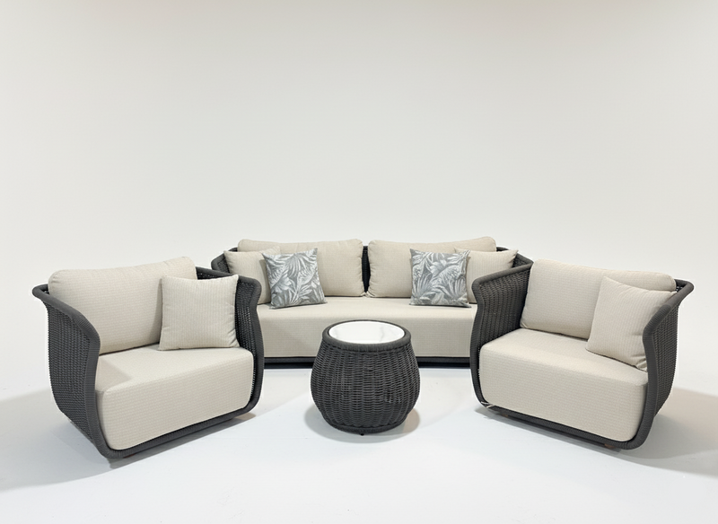 Outdoor furniture set with beige cushions and a small round table on a white background